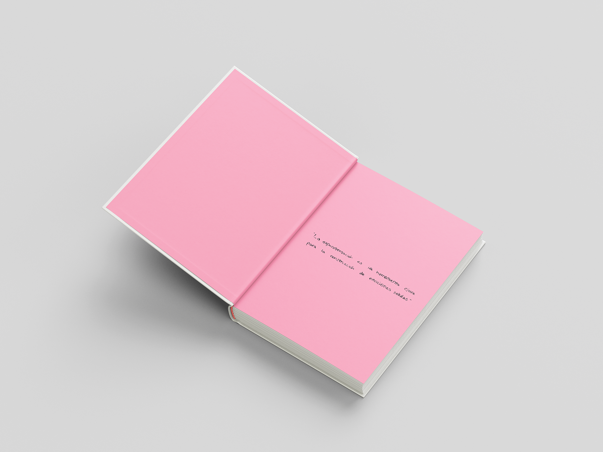 Informe de tendencias abierto sobre fondo gris, con las páginas interiores en rosa y una frase manuscrita sobre la experimentación como herramienta para construir emociones sólidas.